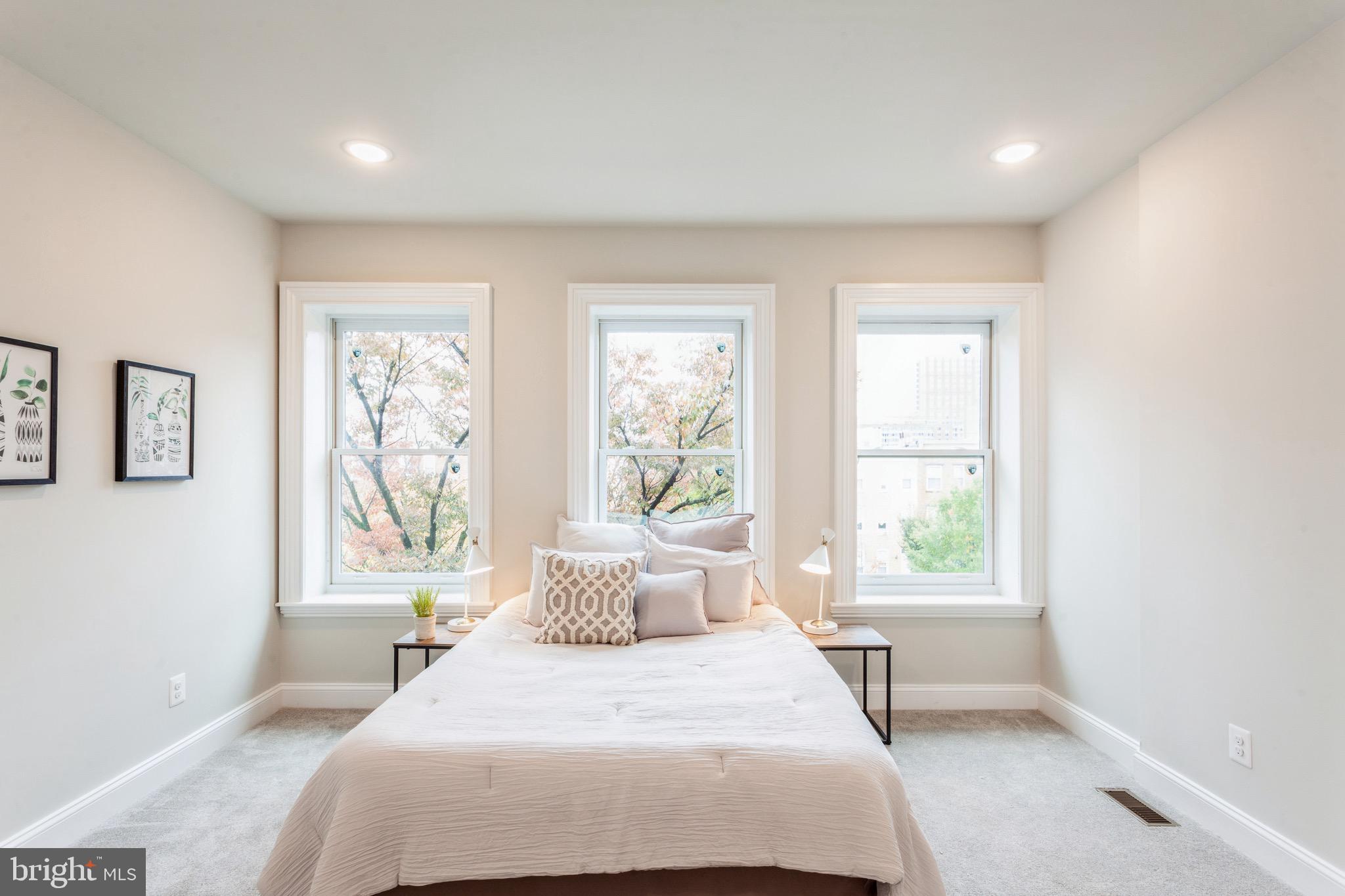 1010 North Broadway Baltimore, MD 21205 - Photo 19 of 37 a bedroom with a large bed and a window
