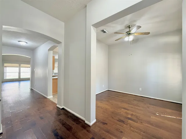 a view of empty room with wooden floor