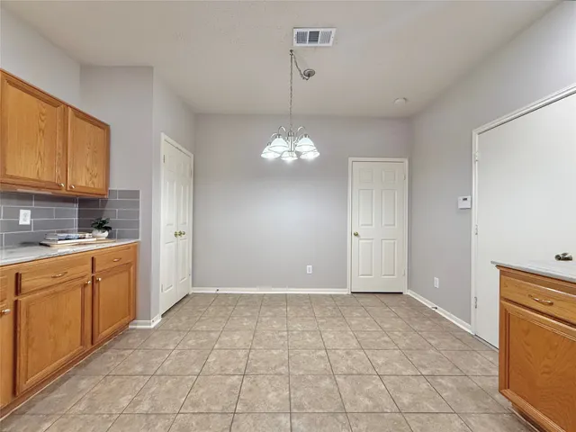 a view of a kitchen with granite countertop cabinets a sink and a counter top space