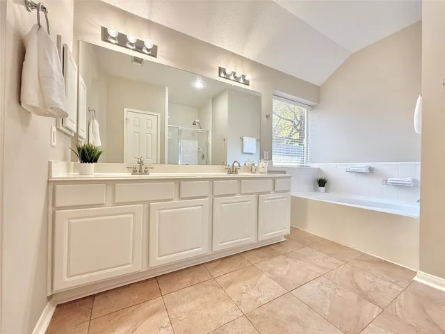 a bathroom with a sink vanity and mirror