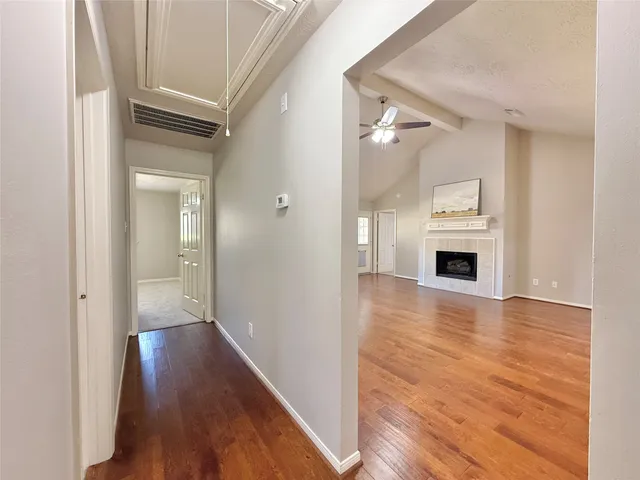 a view of a hallway with wooden floor