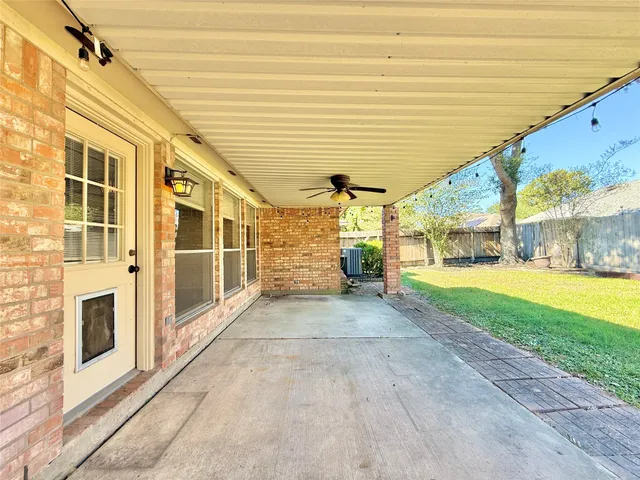 a view of a porch with a table and chairs