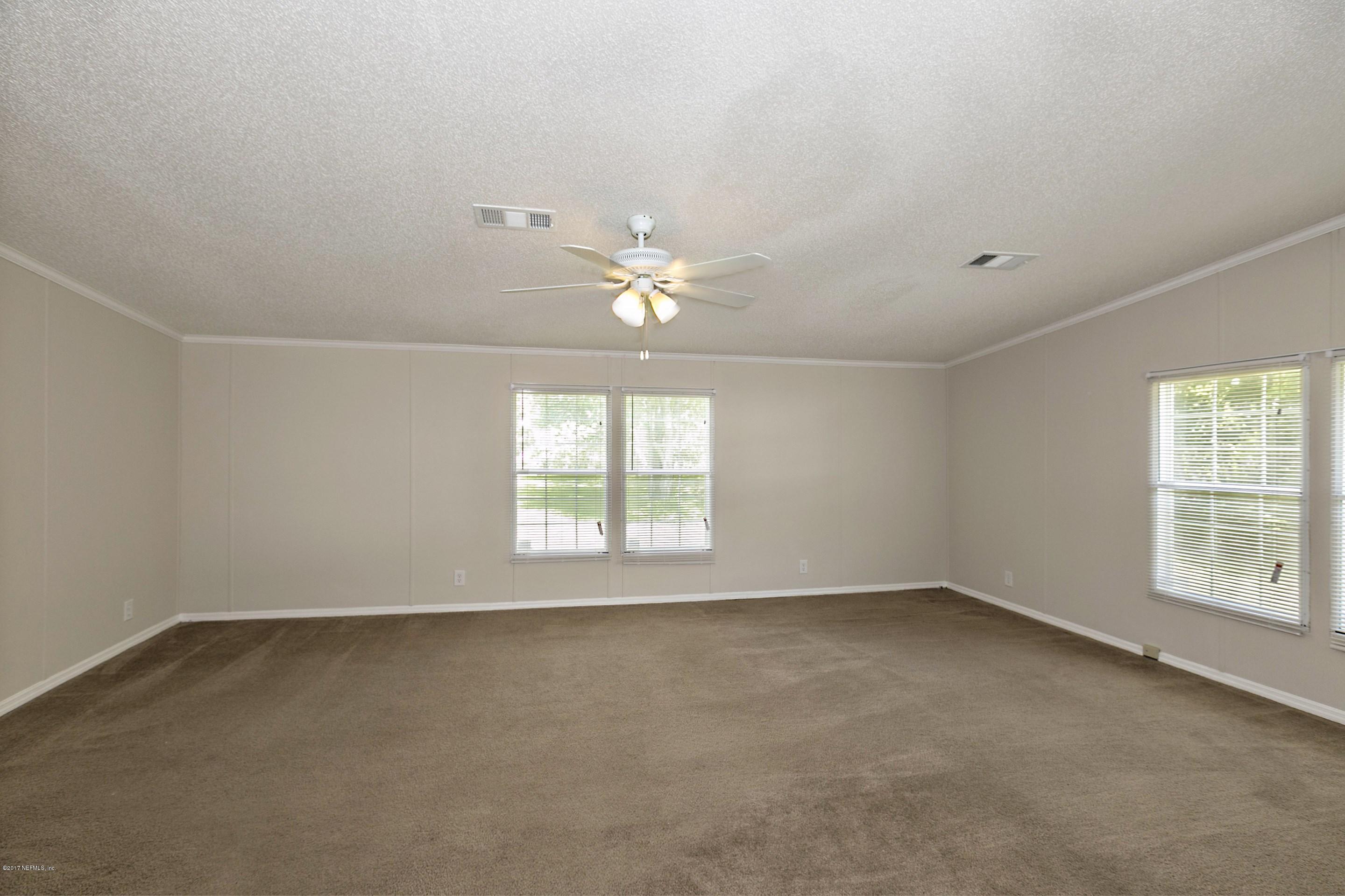 324 Dusty Road St. Augustine, FL 32095 - Photo 12 of 26 an empty room with a window and a ceiling fan
