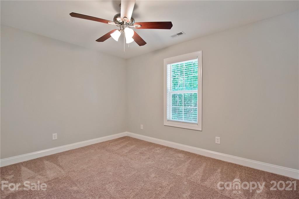 131 Powder Street Southwest Concord, NC 28025 - Photo 14 of 29 an empty room with a window and a fan