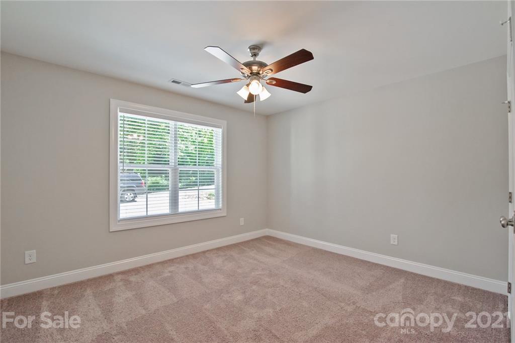 131 Powder Street Southwest Concord, NC 28025 - Photo 16 of 29 an empty room with a window and a fan