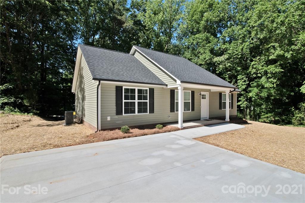 131 Powder Street Southwest Concord, NC 28025 - Photo 20 of 29 a front view of a house with a yard and garage