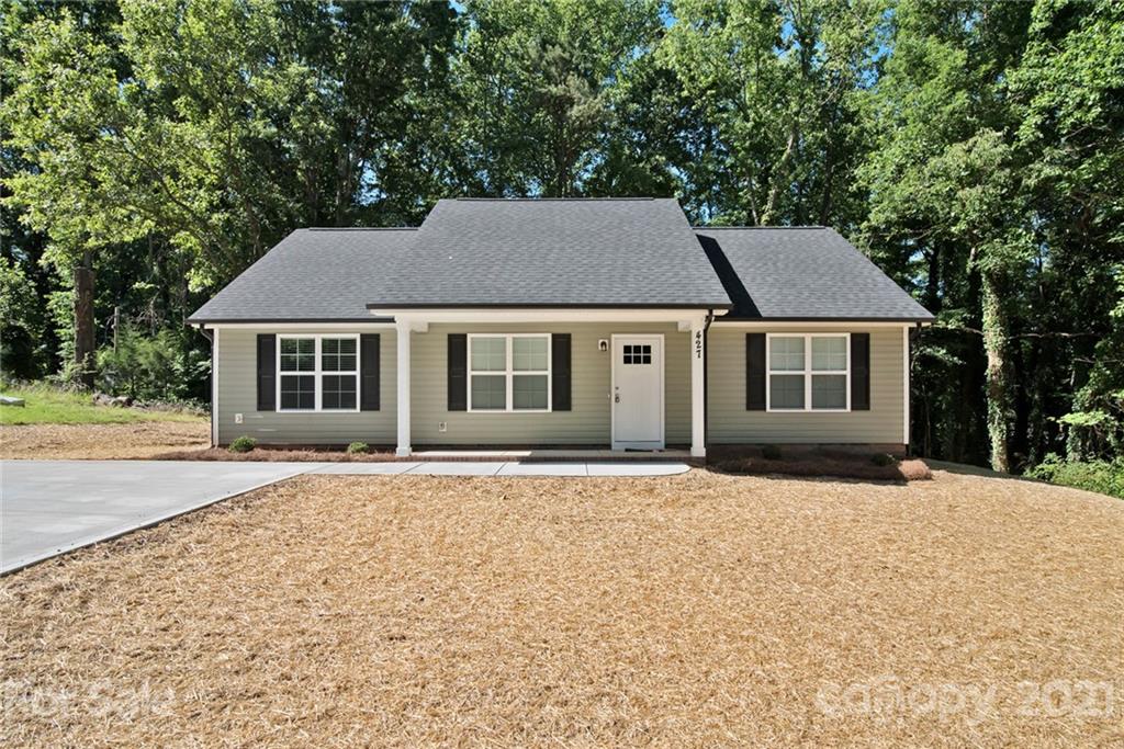 131 Powder Street Southwest Concord, NC 28025 - Photo 21 of 29 a house with trees in the background