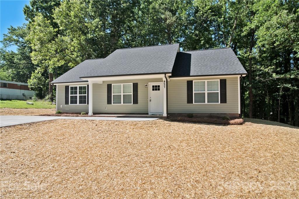 131 Powder Street Southwest Concord, NC 28025 - Photo 22 of 29 a front view of a house with a yard