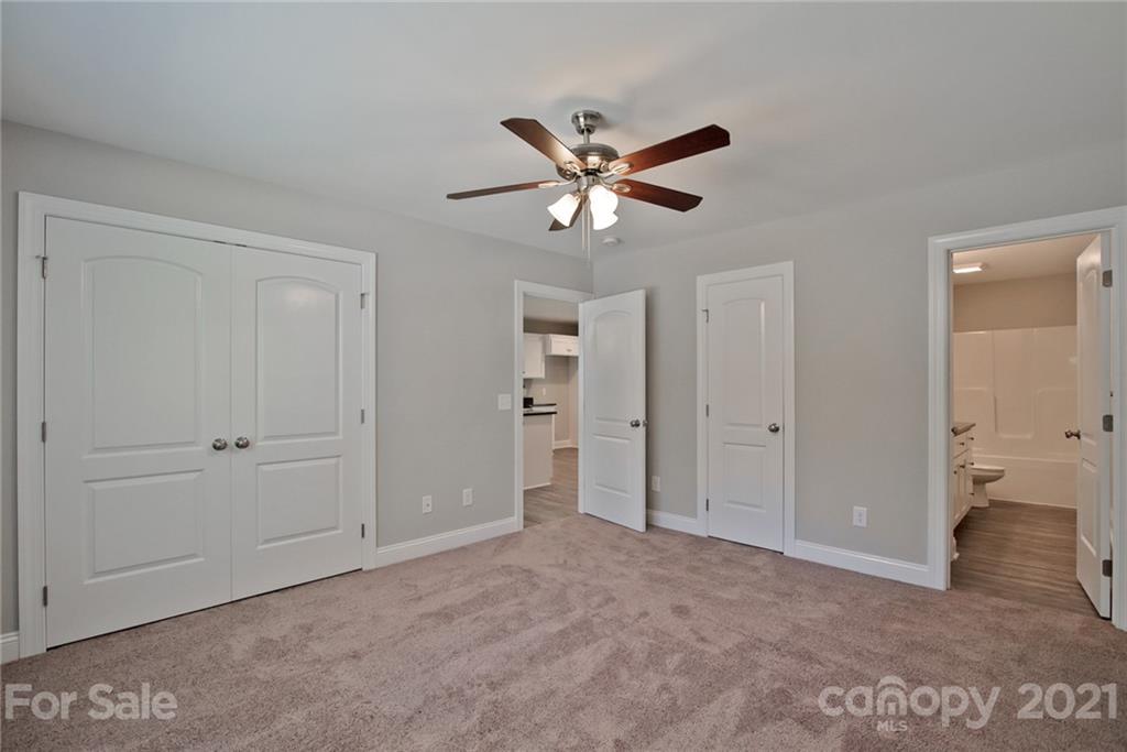 131 Powder Street Southwest Concord, NC 28025 - Photo 5 of 29 a view of an empty room and a bathroom