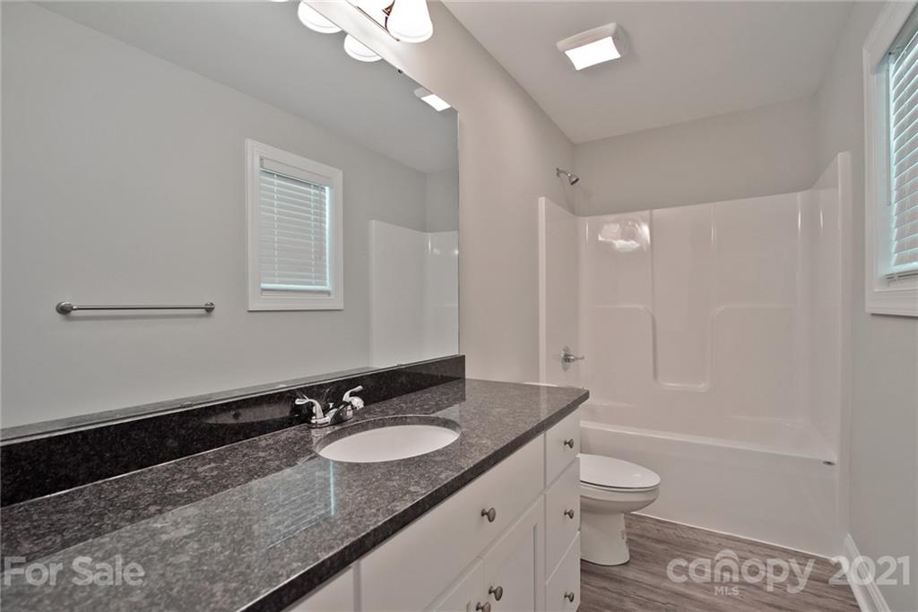 131 Powder Street Southwest Concord, NC 28025 - Photo 6 of 29 a bathroom with a granite countertop sink toilet and shower