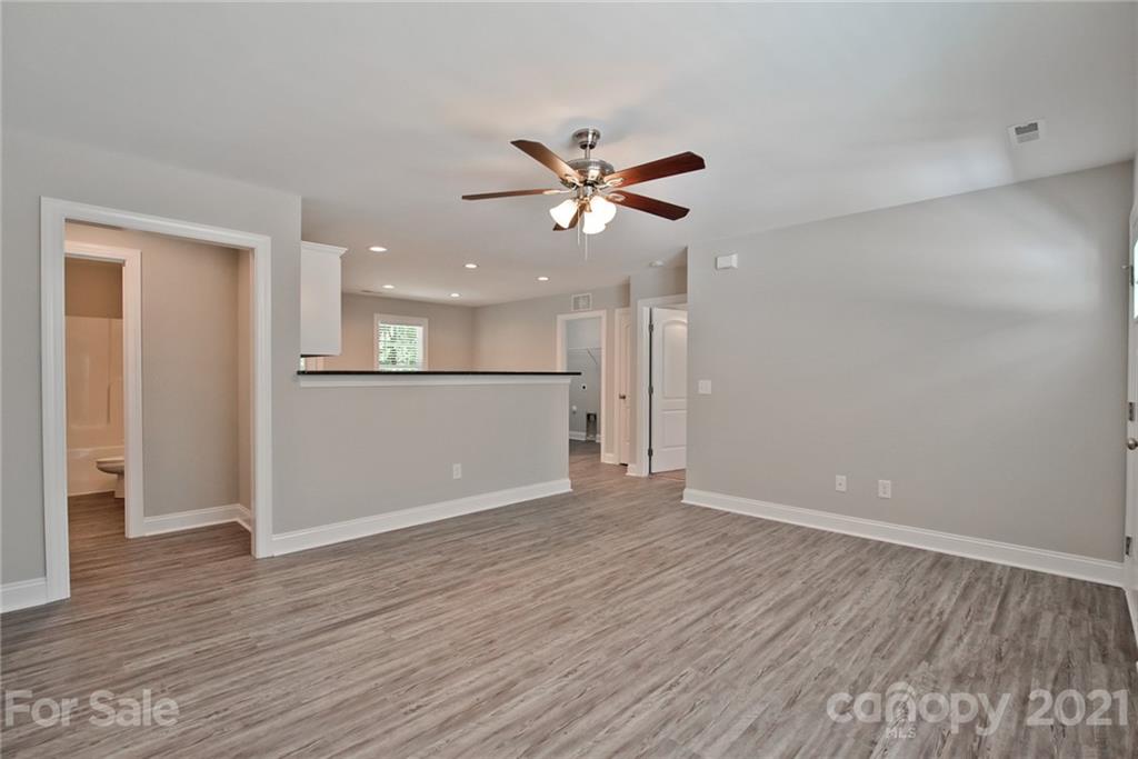 131 Powder Street Southwest Concord, NC 28025 - Photo 7 of 29 wooden floor in an empty room with a window