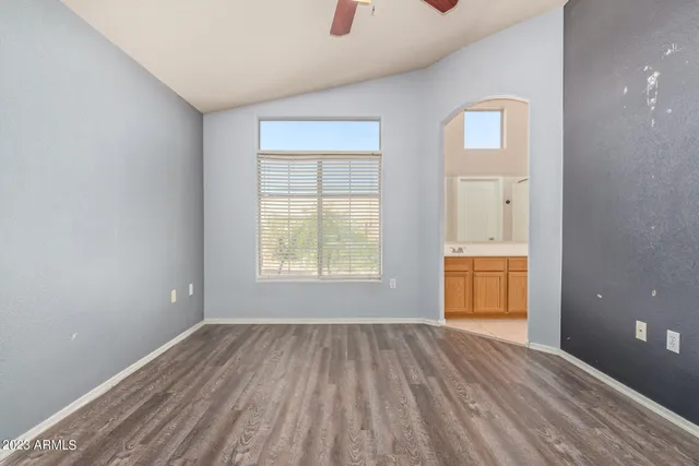 an empty room with windows and closet