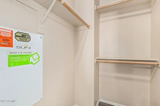 a room with a window and a refrigerator