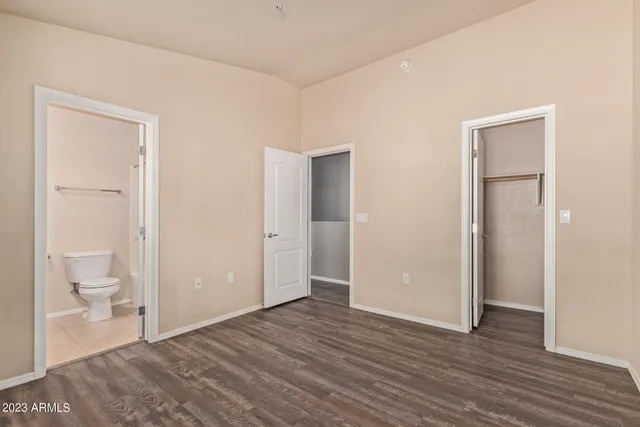a view of a room with wooden floor and a bathroom