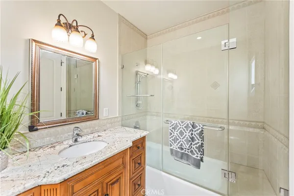 a large white bathroom with a large tub sink and double vanity
