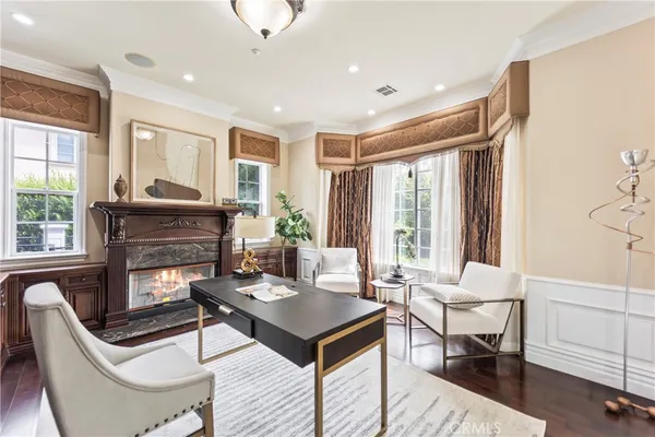 a living room with fireplace furniture and a wooden floor