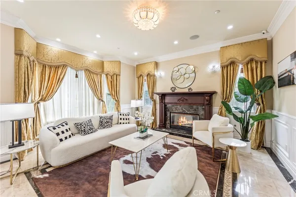 a living room with furniture and a chandelier