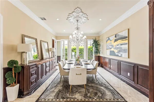 a view of a dining room with furniture wooden floor and chandelier