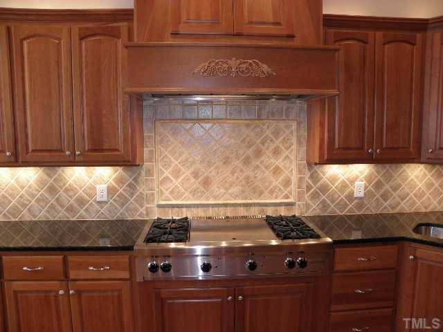 7009 Millstone Ridge Court Raleigh, NC 27614 - Photo 5 of 25 a stove top oven sitting inside of a kitchen