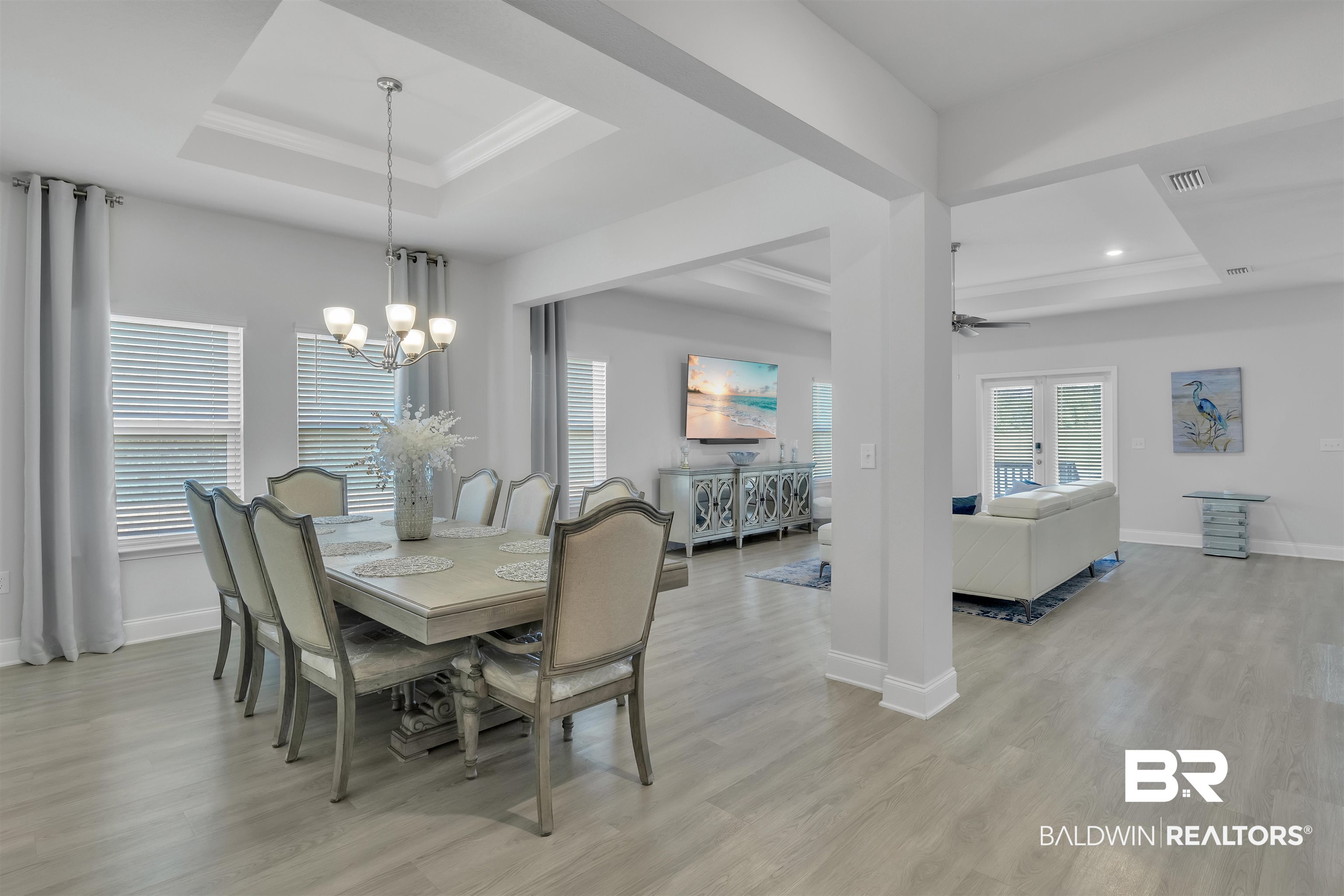 27862 Jade Court Daphne, AL 36526 - Photo 7 of 33 Dining room with visible vents, a tray ceiling, and light wood finished floors