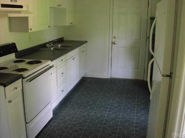 525 Steel Street Raleigh, NC 27603 - Photo 3 of 9 a kitchen with a sink and a refrigerator