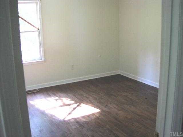 525 Steel Street Raleigh, NC 27603 - Photo 5 of 9 an empty room with wooden floor and windows