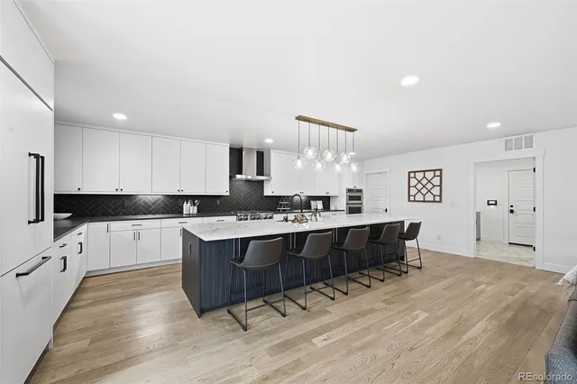 a large kitchen with kitchen island a sink counter space and stainless steel appliances