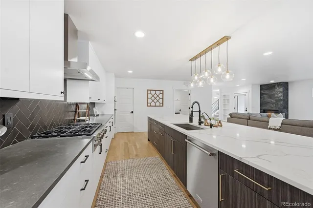 a large kitchen with stainless steel appliances granite countertop a lot of counter space
