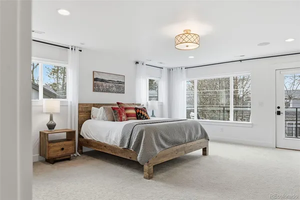 a spacious bedroom with a bed and a window