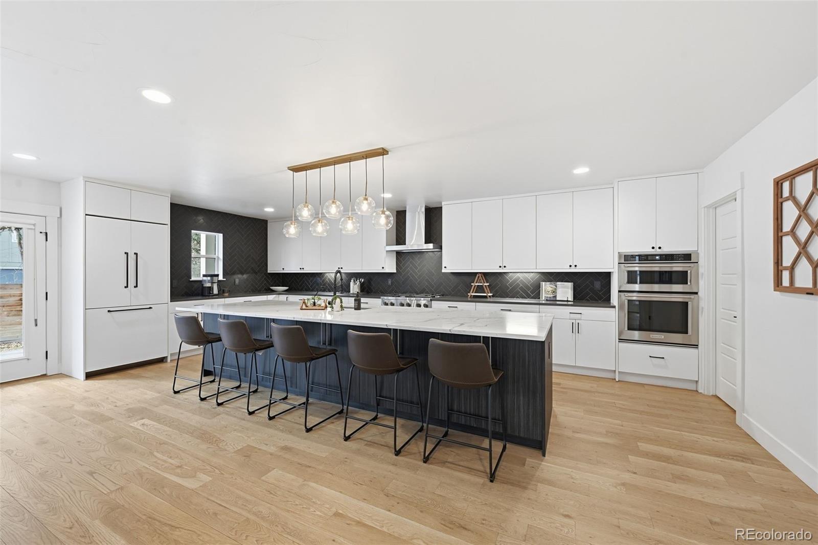 2757 South Steele Street Denver, CO 80210 - Photo 21 of 50 a large kitchen with a table and chairs in it