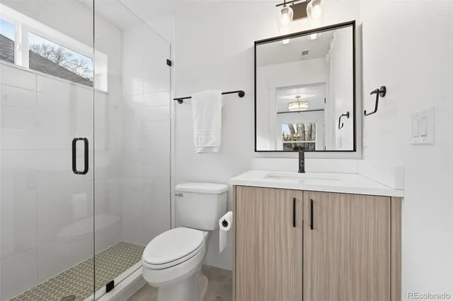 a bathroom with a toilet sink and shower