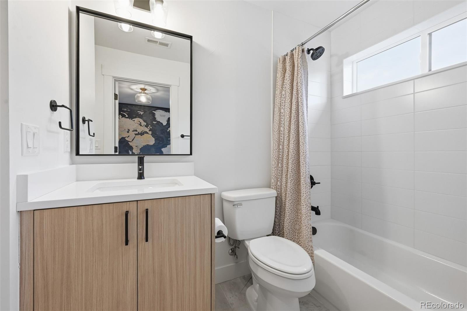 2757 South Steele Street Denver, CO 80210 - Photo 31 of 50 a bathroom with a sink a toilet and shower