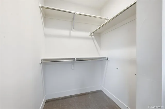 a bed room with a bed and a chair