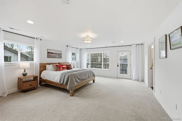 a bedroom with a large bed and a couch