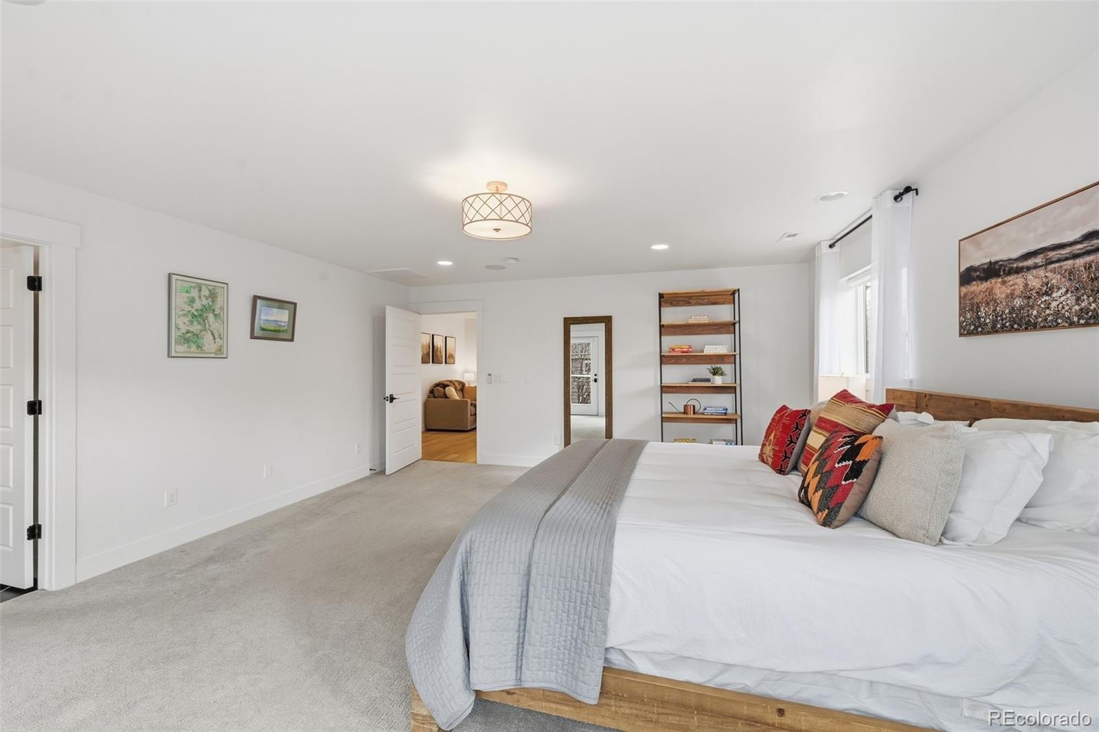 2757 South Steele Street Denver, CO 80210 - Photo 34 of 50 a bedroom with a large bed and a couch