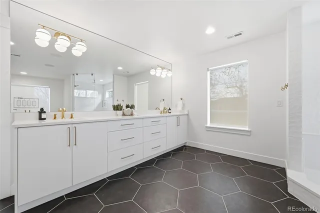 a bathroom with a sink vanity and a mirror