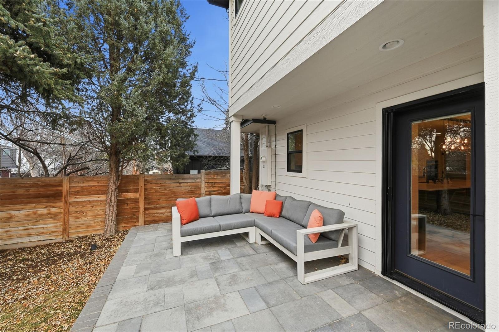 2757 South Steele Street Denver, CO 80210 - Photo 40 of 50 a backyard of a house with barbeque oven table and chairs