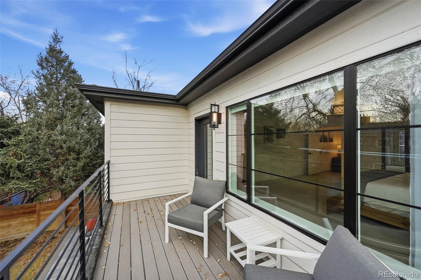 2757 South Steele Street Denver, CO 80210 - Photo 42 of 50 a view of a balcony with chairs and wooden floor