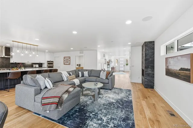 a living room with furniture and kitchen view