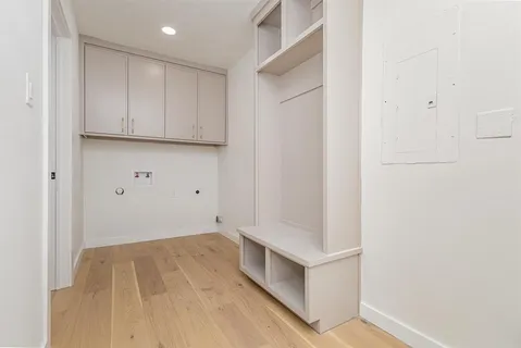 a view of room with hardwood floor and hallway