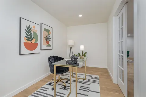 a dining room with wooden floor and glass door
