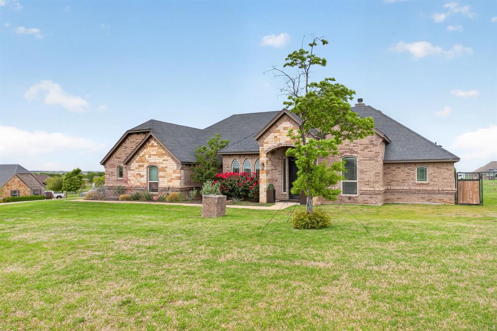 7320 Spring Ranch Court Godley, TX 76044 - Photo 27 of 38 a view of a house with a yard and a garden