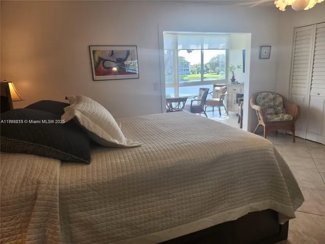 a bedroom with a bed and a chair