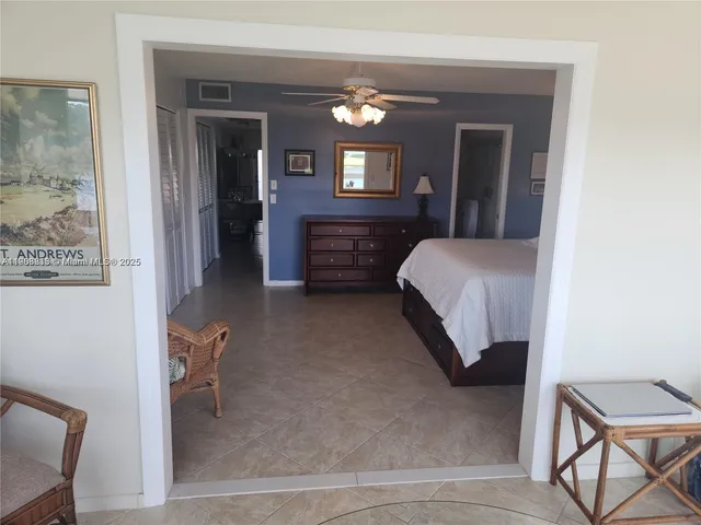 a bedroom with a bed window and a chair