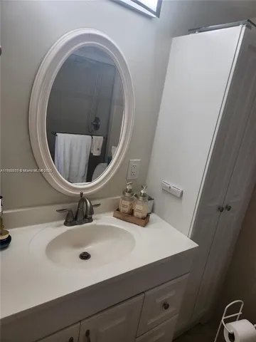 a bathroom with a sink and a mirror
