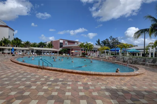 a view of a swimming pool with a table and chairs
