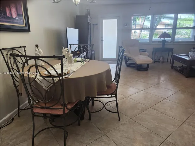 a dining room with furniture and a window