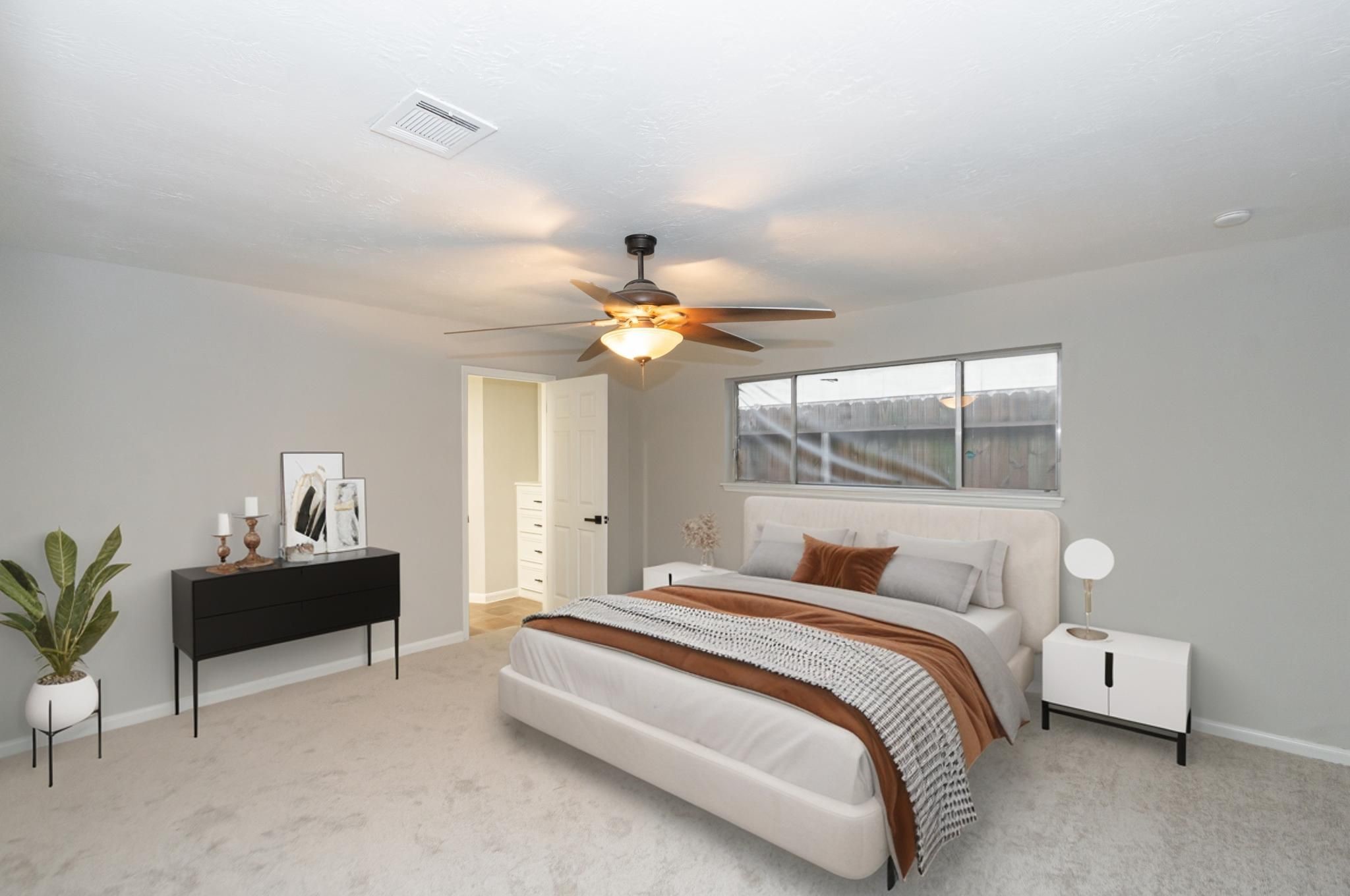 29019 Stapleford Street Spring, TX 77386 - Photo 13 of 27 a bedroom with a bed and a chandelier