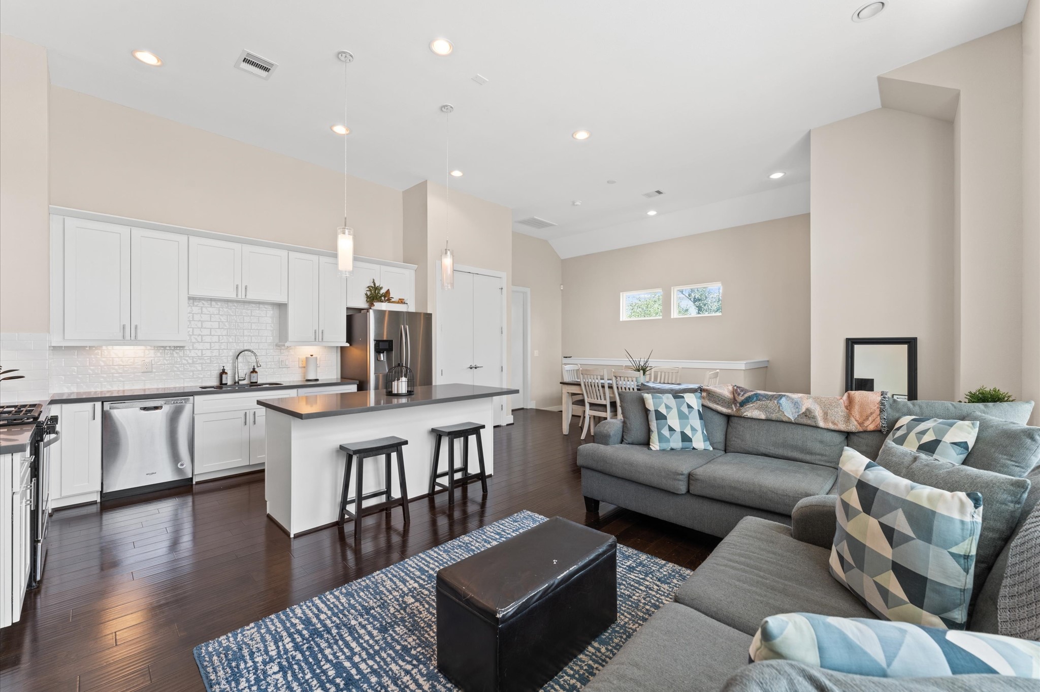 2422 Cochran Street Houston, TX 77009 - Photo 2 of 31 Relax under 12-foot ceilings with ample recessed lighting. Enjoy the breakfast bar that separates the living room and kitchen area. Add a few barstools for additional casual seating for mealtime.
