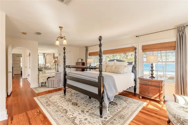 a bedroom with furniture and a large window